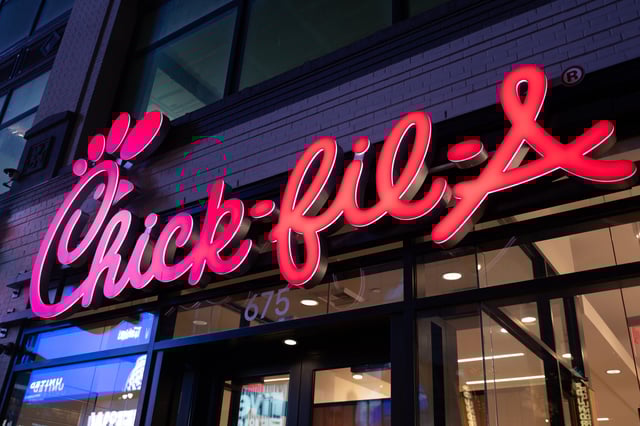 Facade of a Chick-fil-A restaurant with illuminated signage at night, New York City, New York, October 19, 2024.