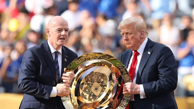 Gianni Infantino, President of FIFA and U.S. President Donald Trump present the FIFA Club World Cup trophy during the FIFA Club World Cup 2025 final 