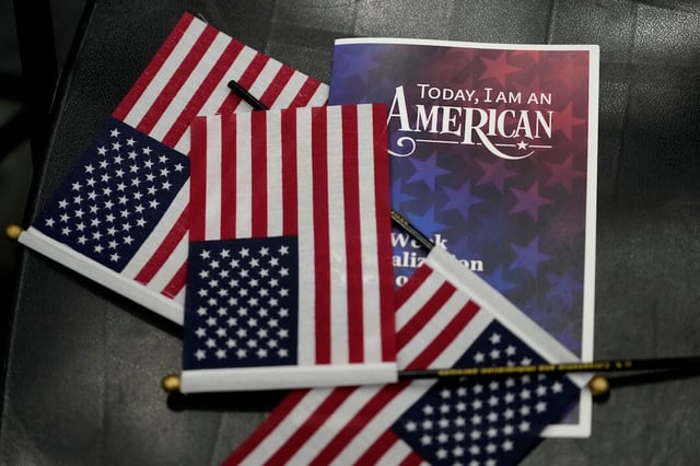 American flags sit on a chair during a naturalization ceremony aboard the USS Bataan during Fleet Week Miami at PortMiami, Tuesday, May 7, 2024, in Miami. (AP Photo/Lynne Sladky)