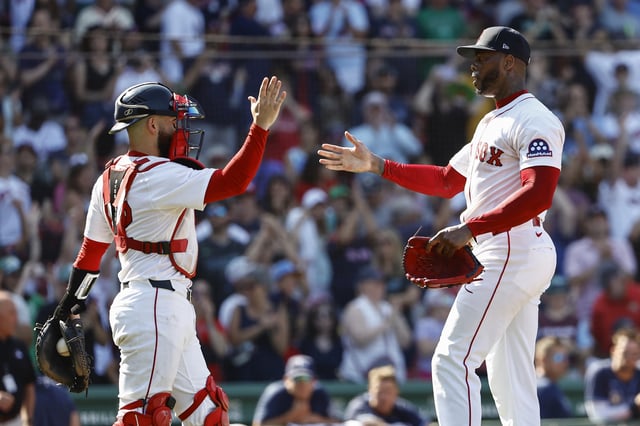 BOSTON, MA - JULY 13: Catcher Connor Wong #12 of the Boston Red Sox congratulates Aroldis Chapman #44 after their 4-1 win over the Tampa Bay Rays at Fenway Park on July 13, 2025 in Boston, Massachusetts.