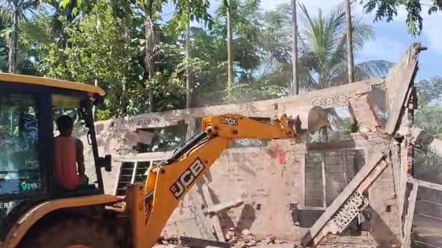 Demolition work underway in illegally occupied land in Assam. (HT Photo)