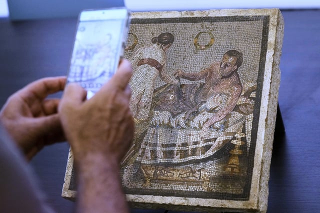 A Roman mosaic depicting a pair of lovers, which was repatriated from Germany, is displayed to journalists in the auditorium of Pompeii archaeological park, Tuesday, July 15, 2025. (AP Photo/Gregorio Borgia)