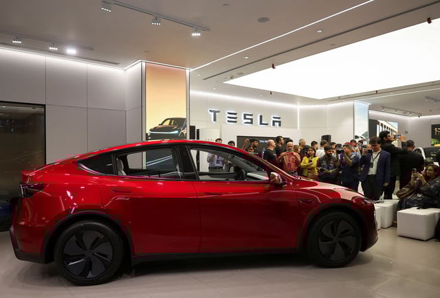 Media personnel take pictures and videos of the TESLA Model Y car at India's first Tesla showroom in Mumbai, India, July 15, 2025.