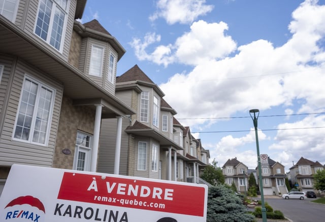 A "for sale" sign is seen in front of a home in Laval, Que., on Friday, July 4, 2025. For the second time this year, the Canadian Real Estate Association has downgraded its forecast for home sales activity in 2025, as it reported that the number of homes that changed hands across the country in June rose 3.5 per cent compared with a year ago. THE CANADIAN PRESS/Christinne Muschi