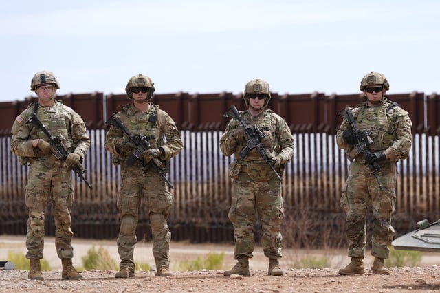 Members of the U.S. Army 212 Infantry 2nd Brigade stand next to the US-Mexico border wall, as part of Joint Task Force Southern Border, Thursday, April 3, 2025, in Douglas, Ariz.