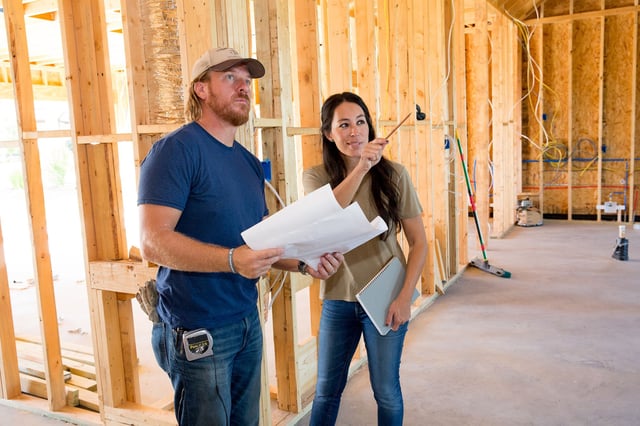 Joanna Gaines visiting husband Chip to check in on the progression of the Pahmiyer home, as seen on Fixer Upper. Joanna points out where is she wanting to put a fireplace.
