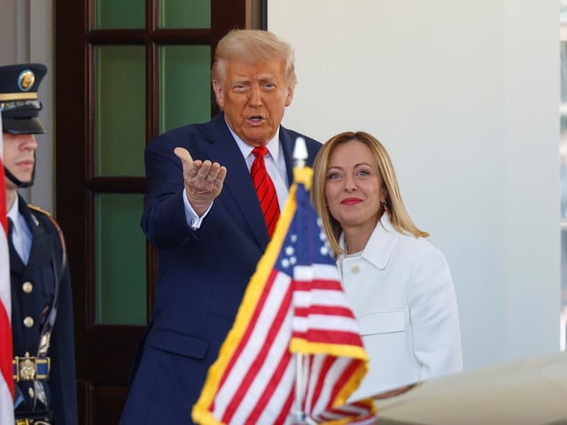 President Donald Trump, center, greets Italy's Prime Minister Giorgia Meloni, right, upon her arrival at the White House, Thursday, April 17, 2025, in Washington. (AP Photo/Tom Brenner)