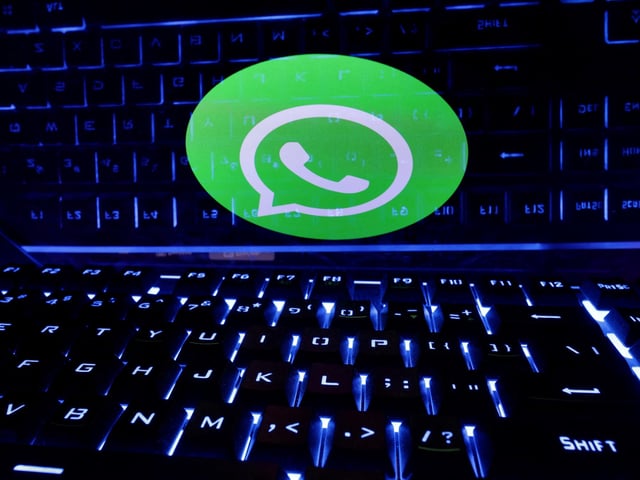 FILE PHOTO: A keyboard is placed in front of a displayed WhatsApp logo in this illustration taken February 21, 2023. REUTERS/Dado Ruvic/Illustration/File Photo