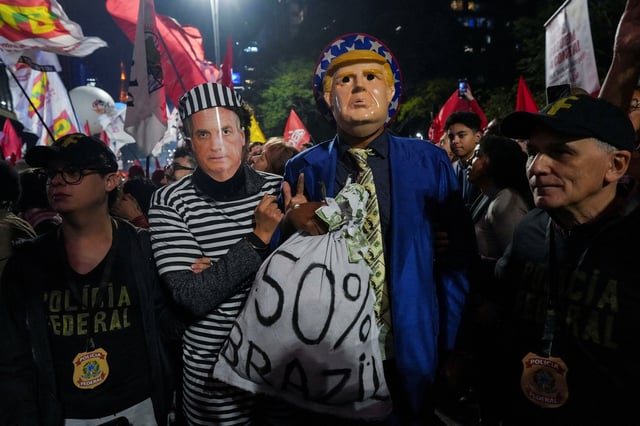 Demonstrators wearing costumes and masks depicting former Brazilian President Jair Bolsonaro and U.S. President Donald Trump take part in a protest against U.S. President Donald Trump's announcement of 50% tariffs on Brazilian products, in Sao Paulo, Brazil July 10, 2025. REUTERS/Alexandre Meneghini/File Photo