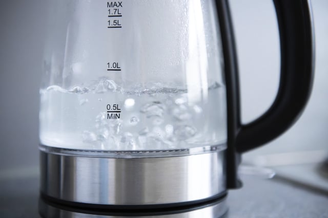 File photo: Tap water boils in a kettle in a kitchen.