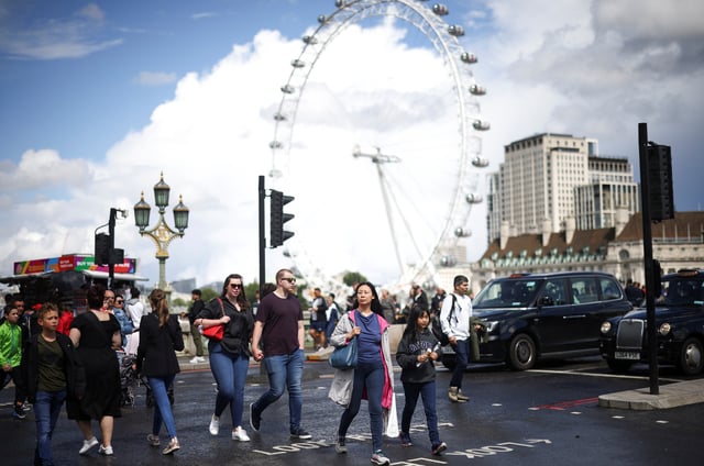 FILE PHOTOl People walk over Westminster Bridge in London, Britain, August 7, 2021. REUTERS/Henry Nicholls/File Photo