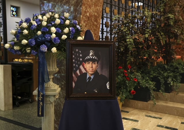 A large photo of police Officer Andrés Mauricio Vásquez Lasso is displayed before the start of his funeral Mass at St. Rita of Cascia Shrine Chapel on March 9, 2023, in Chicago. Vásquez Lasso was fatally shot in the line of duty in the Gage Park neighborhood on March 1, 2023. (Stacey Wescott/Chicago Tribune)