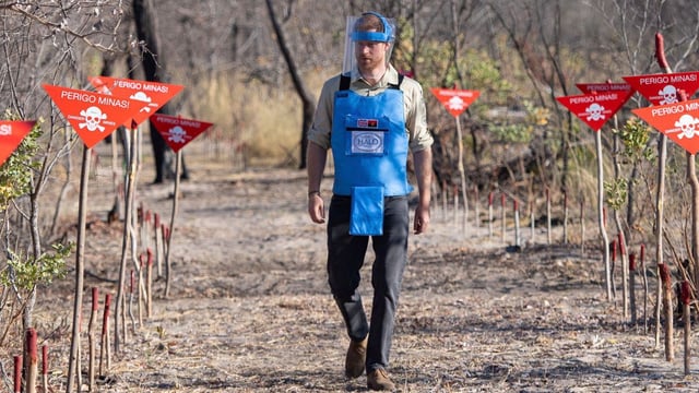 Harry walks through a minefield in Dirico, Angola, during a visit to see the work of the Halo Trust in September 2019