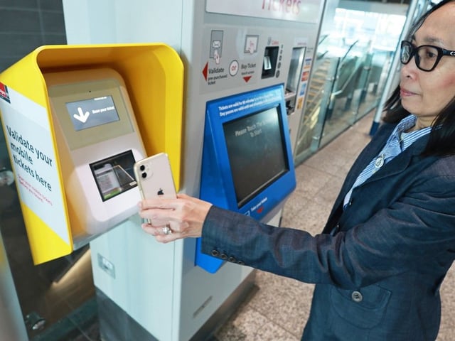 Tess Abanto, Calgary Transit manager with Transit Service Design demonstrates a mobile ticket scanner at the Westbrook CTrain station on Tuesday, July 15, 2025. Beginning Wednesday, July 16, 2025, customers riding the CTrain must scan their activated mobile tickets at platforms before boarding a CTrain. 
Gavin Young/Postmedia