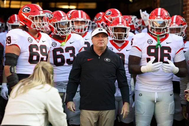 Georgia head coach Kirby Smart walks out with Georgia offensive lineman Tate Ratledge, offensive lineman Sedrick Van Pran and defensive lineman Zion Logue before their game against Tennessee at Neyland Stadium, Saturday, Nov, 18, 2023, in Knoxville, Tennessee.