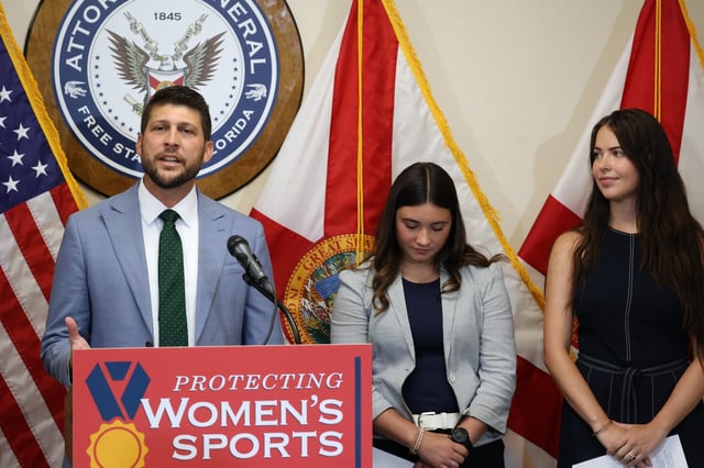 Florida Attorney General James Uthmeier speaks during a news conference at the Orlando Office of the Attorney General on Tuesday, July 15, 2025, where he asserted that U.S. Masters Swimming, a nonprofit in Florida, should no longer allow transgender athletes to compete against women swimmers — or face legal action. Also pictured with Uthmeier, Cassidy Carlisle and Lainey Armistead, advocates against transgender athlete participation in women’s sports. (Rich Pope/Orlando Sentinel)