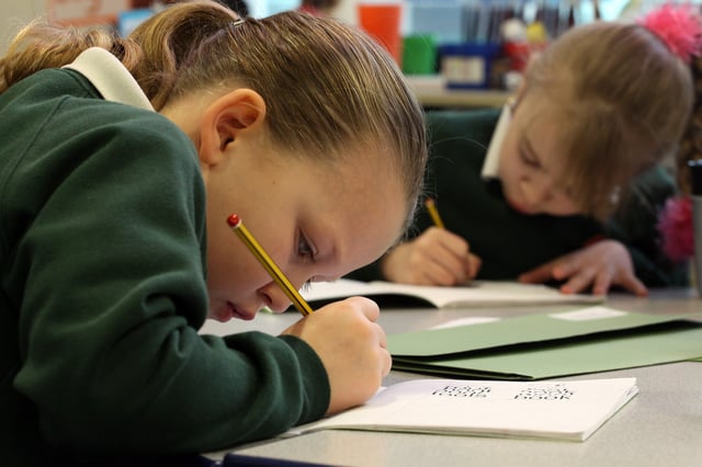 BRISTOL, UNITED KINGDOM - FEBRUARY 24:  A primary school pupil at the Bridge Learning Campus completes her school work in a classroom at the school on February 24, 2010 in Bristol, England. The 40million GBP campus in Hartcliffe, Bristol, was constructed as part of the Government&#39;s Building Schools for the Future programme and opened in January 2009.  It now offers over 800 pupils a life long provision of learning from nursery, reception and primary to secondary and post-16 education. As the UK gears up for one of the most hotly contested general elections in recent history it is expected that that the economy, immigration, the NHS and education are likely to form the basis of many of the debates.  (Photo by Matt Cardy/Getty Images)