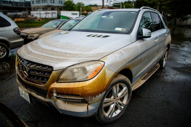 Water marks appear on a car as a result of heavy flooding in the Elmsford area of Westchester, New York, U.S., July 15, 2025.  REUTERS/Eduardo Munoz
