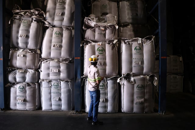 A worker stands in a coffee warehouse in Guaxupe, Brazil, February 18, 2025. REUTERS/Carla Carniel/ File Photo
