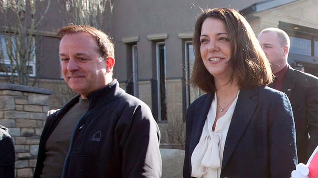 Then-Wildrose Leader Danielle Smith leaves a polling station with her husband David Moretta, left, in High River, Alberta to cast her ballot for the Alberta election Monday, April, 23, 2012. 