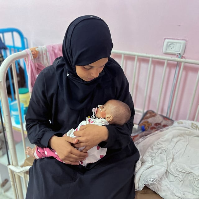 Palestinian mother Israa Abu Haleeb looks after her five-month-old daughter, Zainab, who medics diagnosed with malnutrition, at Nasser hospital in Khan Younis, in the southern Gaza Strip on Tuesday.