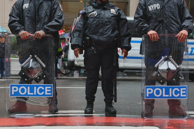 NYPD prepares to escort people as they march in the "No Kings" protest along Fifth Avenue on June 14, 2025 in New York, New York.