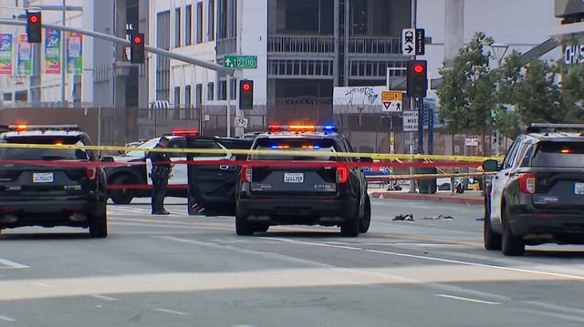LAPD officers and patrol cars at the scene of a police shooting along Figueroa Blvd. in Downtown LA July 13 after officers say they confronted and shot a man armed with a machete.