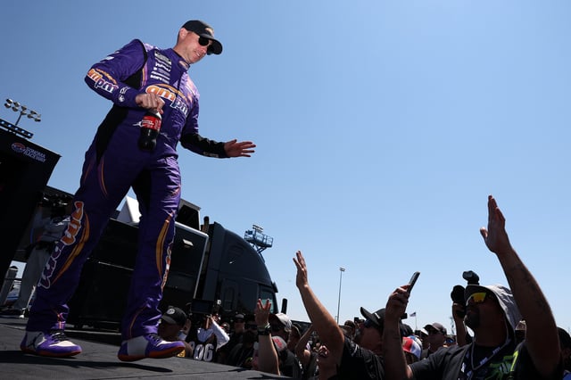 Denny Hamlin, driver of the #11 ampm Toyota, greets fans as he walks onstage during driver intros prior to the NASCAR Cup Series Toyota/Save Mart 350 at Sonoma Raceway on July 13, 2025 in Sonoma, California.