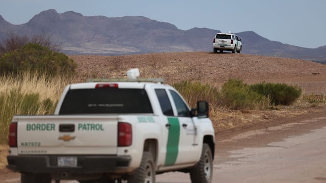 Border Patrol vehicles are seen along the fence at the southern US border with Mexico, in Douglas, Ariz. Photo: David Swanson/AFP via Getty Images