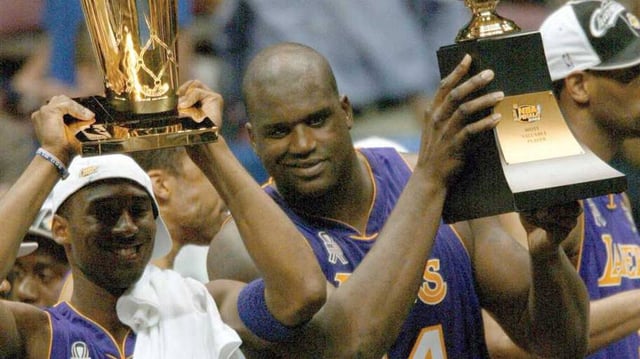 June 12, 2002; East Rutherford, NJ, USA; (left to right) Los Angeles Lakers Kobe Bryant and Shaquille O'Neal hold trophies after winning the championship in Game 4 of the NBA Finals at The Meadowlands.  Mandatory Credit: Robert Deutsch-Imagn Images