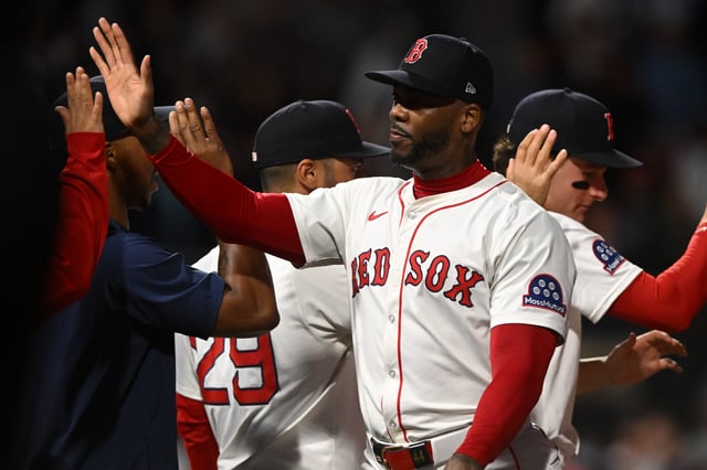 BOSTON, MASSACHUSETTS - JULY 10: Aroldis Chapman #44 of the Boston Red Sox high fives teammates after a 4-3 win against the Tampa Bay Raysc at Fenway Park on July 10, 2025 in Boston, Massachusetts.