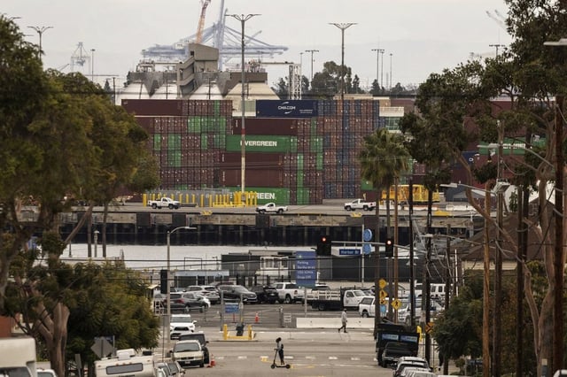 A person on a scooter crosses a street in a residential area located right next to the Port of Los Angeles, Tuesday, March 11, 2025, in San Pedro, Calif. Opinder Singh Sian was at the centre of a vast conspiracy to import precursor chemicals from China and export narcotics through the port of Los Angeles to Australia.