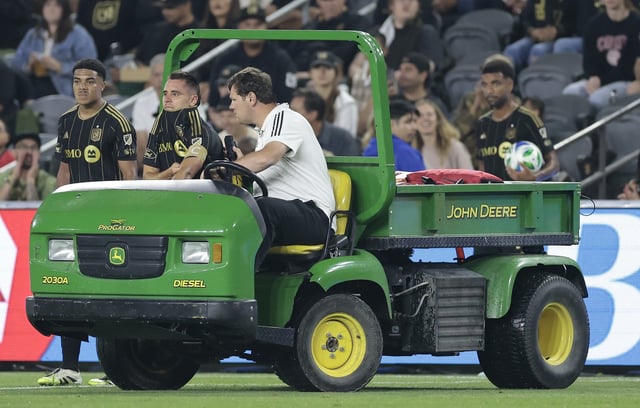 LAFC center back Aaron Long, front left, is driven off the field in a cart after suffering a ruptured Achilles tendon during the second half of a game against FC Dallas on Saturday night at BMO Stadium in Los Angeles. (Photo by Ronald Martinez/Getty Images)