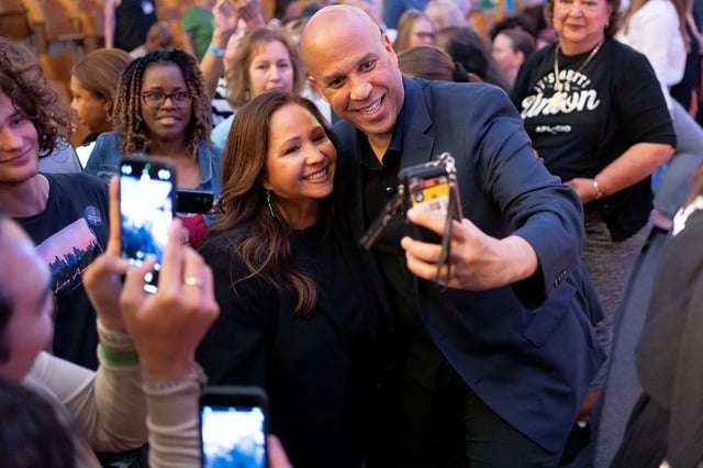 Sen. Cory Booker takes a selfie with Democratic candidate for the US House of Representatives Adelita Grijalva after a town hall in Republican US Rep. Juan Ciscomani's district at Catalina High School in Tucson, Arizona, on April 13.
