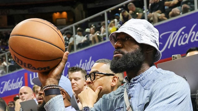 LeBron James of the Los Angeles Lakers throws the ball back to a referee as he attends a 2025 NBA Summer League game 