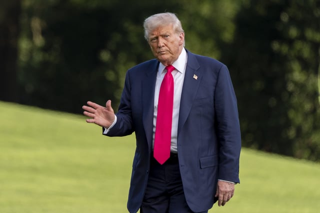 President Donald Trump waves as he walks from Marine One after arriving on the South Lawn of the White House, Tuesday, July 15, 2025, in Washington.