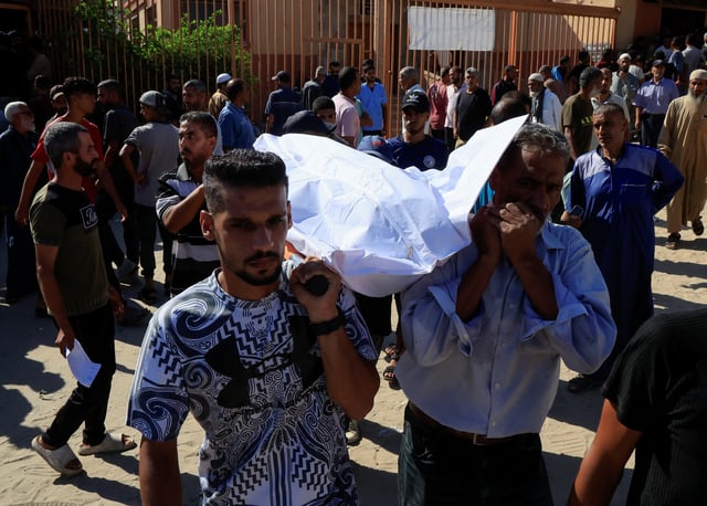 People carry a body as they mourn Palestinians who were killed in an incident on Wednesday while seeking aid in Khan Younis, at Nasser hospital in Khan Younis in the southern Gaza Strip July 16, 2025. REUTERS/Hatem Khaled