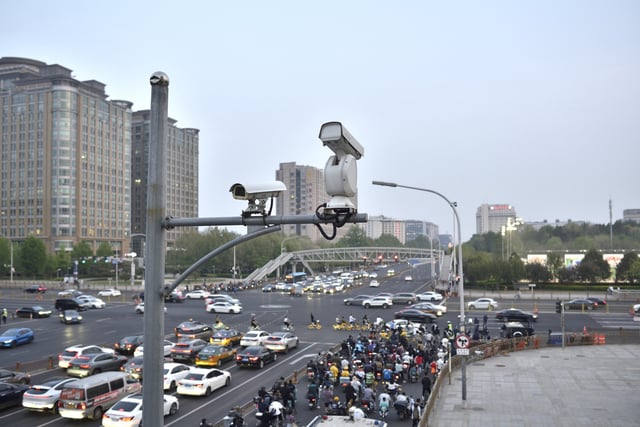 CCTV surveillance cameras monitoring a major road near Tiananmen Square in the Chinese capital, Beijing, on 18 April 2024. Rights groups fear a new online identification system will increase surveillance of internet users and further stifle free speech.