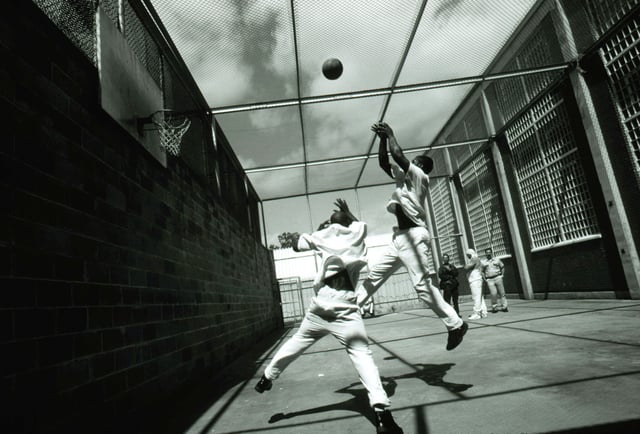 Death row prisoner Ronald Ray Howard, 23, and an unidentified prisoner play basketball April 21, 1997 in the exercise area of the old death row unit, where prisoners had more privileges.