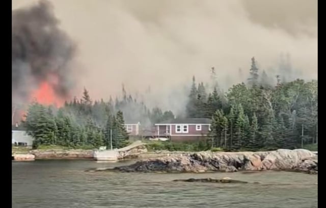 The Chance Harbour fire continues to burn July 16 and has reportedly destroyed most of the cabins in Puddin' Cove.