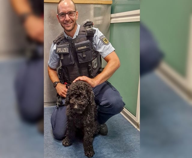 Ein Bundespolizist mit dem vierbeinigen Schwarzfahrer.