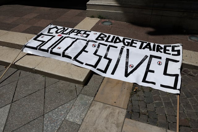 A banner which reads "Successive budget cuts' is seen on the ground during a demonstration organised by the CGT Spectacle labour union to denounce budget cuts in the cultural sector, in Avignon, France, July 16, 2025.  REUTERS/Manon Cruz