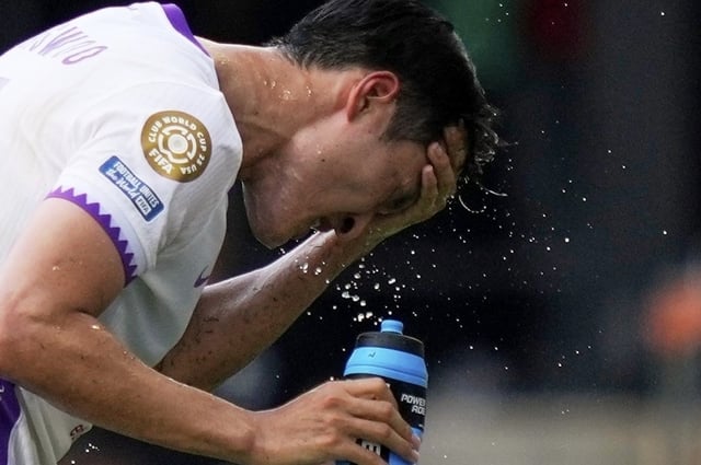FILE - Al Ain's Park Yong-woo splashes his face to cool off during the Club World Cup Group G soccer match between Wydad AC and Al Ain FC in Washington, June 26, 2025. 