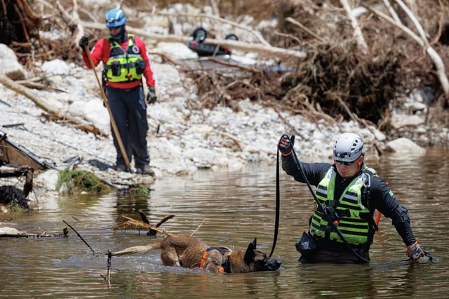 A team of firefighters from Ciudad Acuña, Mexico, conducts search operations in the Guadalupe River near Camp Mystic on July 10,