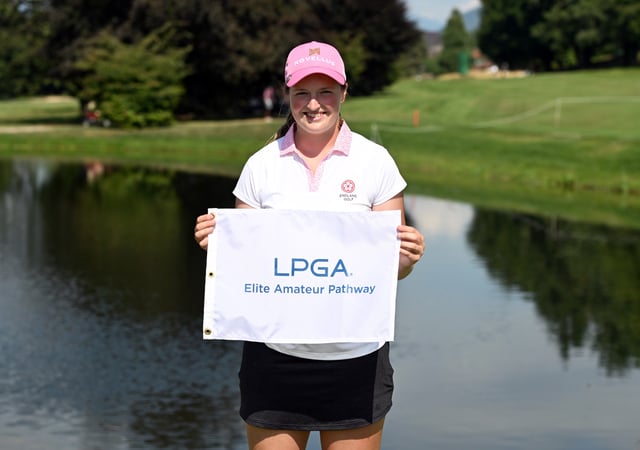 Lottie Woad of England poses for a photograph with a LPGA Elite Amateur Pathway flag after the final round of The Amundi Evian Championship 2025 at Evian Resort Golf Club on July 13, 2025 in Evian-les-Bains, France.