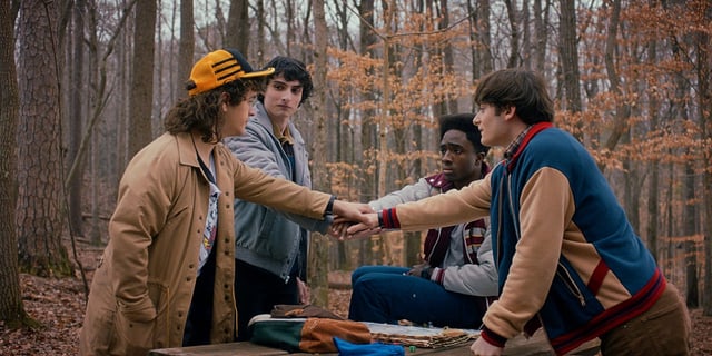 Dustin Henderson, Mike Wheeler, Lucas Sinclair, and Will Byers putting their hands together in the trailer for Stranger Things Season 5