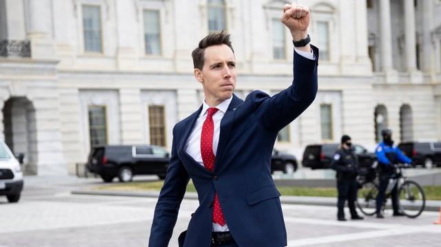 Sen. Josh Hawley (R-Mo.) gestures toward a crowd of supporters of President Donald Trump gathered outside the U.S. Capitol to protest the certification of President-elect Joe Biden&#39;s electoral college victory Jan. 6, 2021 at the US Capitol in Washington, DC. Some demonstrators later breached security and stormed the Capitol.