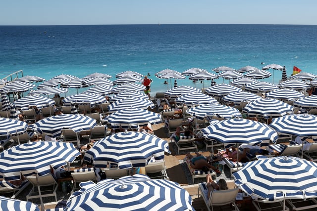 A view shows a beach with deckchairs and parasols on a sunny summer day on the Promenade des Anglais in Nice, France, July 8, 2025. REUTERS/Kevin Coombs/File Photo