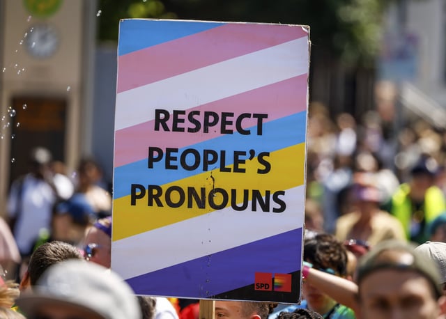 File photo of someone carrying a sign reading &#34;Respect People&#39;s Pronouns&#34; during the Christopher Street Day (CSD) parade in Oldenburg, taken 21 June 2025.