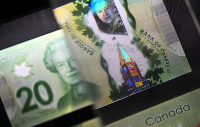 A magnifying glass enlarges the holographic image of Parliament Hill's Peace Tower on a 20 dollar bill issued by the Bank of Canada, shown in a display case at the Bank of Canada Museum in Ottawa, on Wednesday, Sept. 4, 2024. 